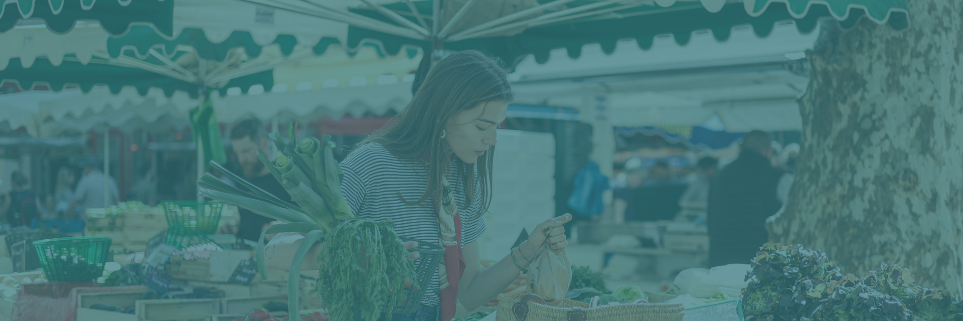 A local shopping for produce at an outdoor market